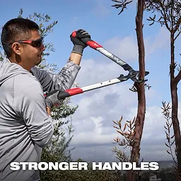 Person using a 1-1/2” Lopper​ to cut a tree branch outdoors, with text reading STRONGER HANDLES.