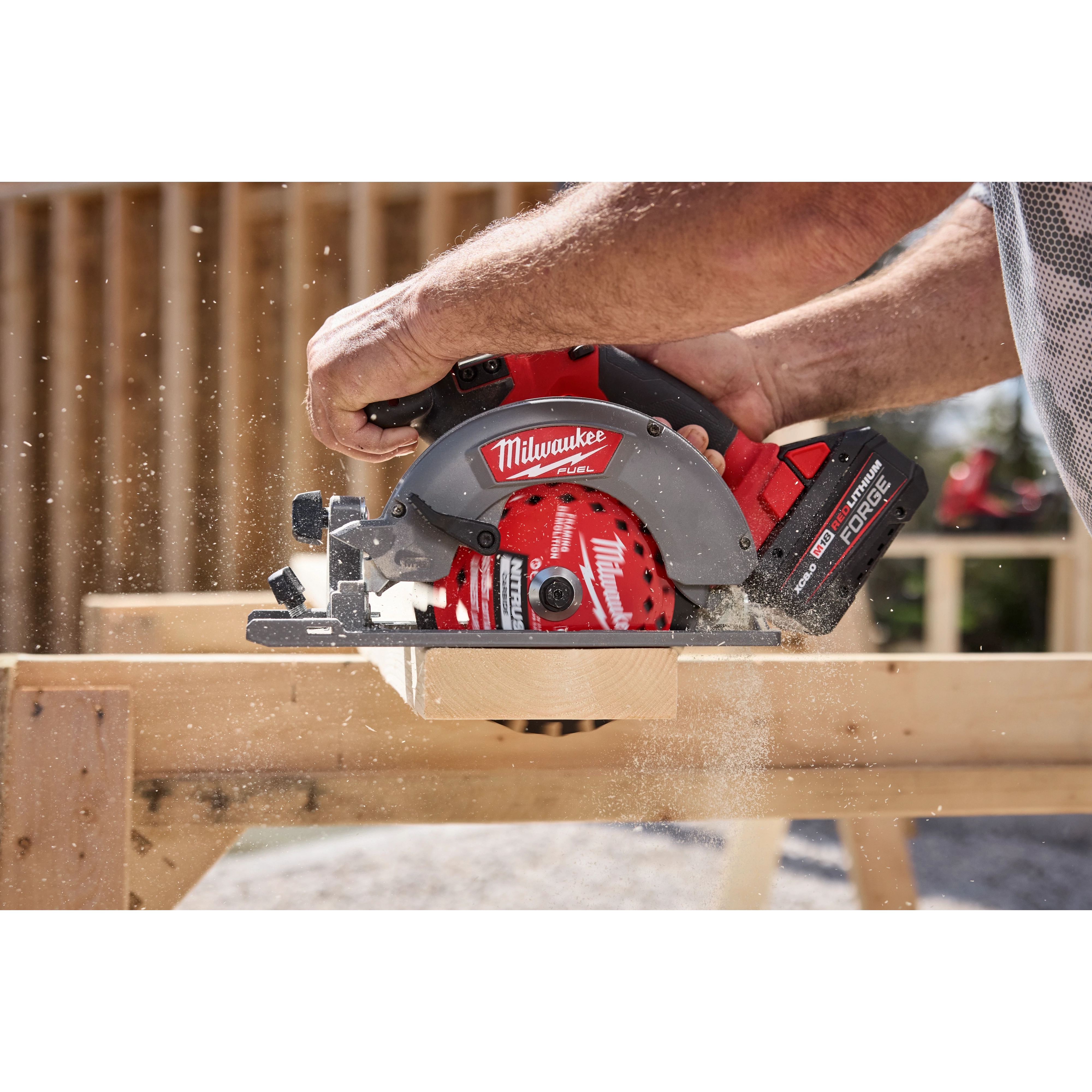 6-1/2” 24T NITRUS Carbide Framing & Demolition Circular Saw Blade cutting through a wooden board outdoors.