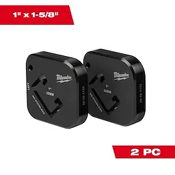 Two black Milwaukee 1" x 1-5/8" metal dies, labeled "25MM" and "NO STAINLESS," with