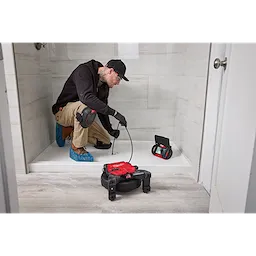 Image of the Milwaukee M12™ 65’ Ultra Flex Compact Inspection Camera Kit being used by a worker on a jobsite