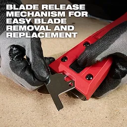 Gloved hands removing the blade from the AIR-TIP Debris Scraper, highlighting the blade release mechanism for easy replacement.