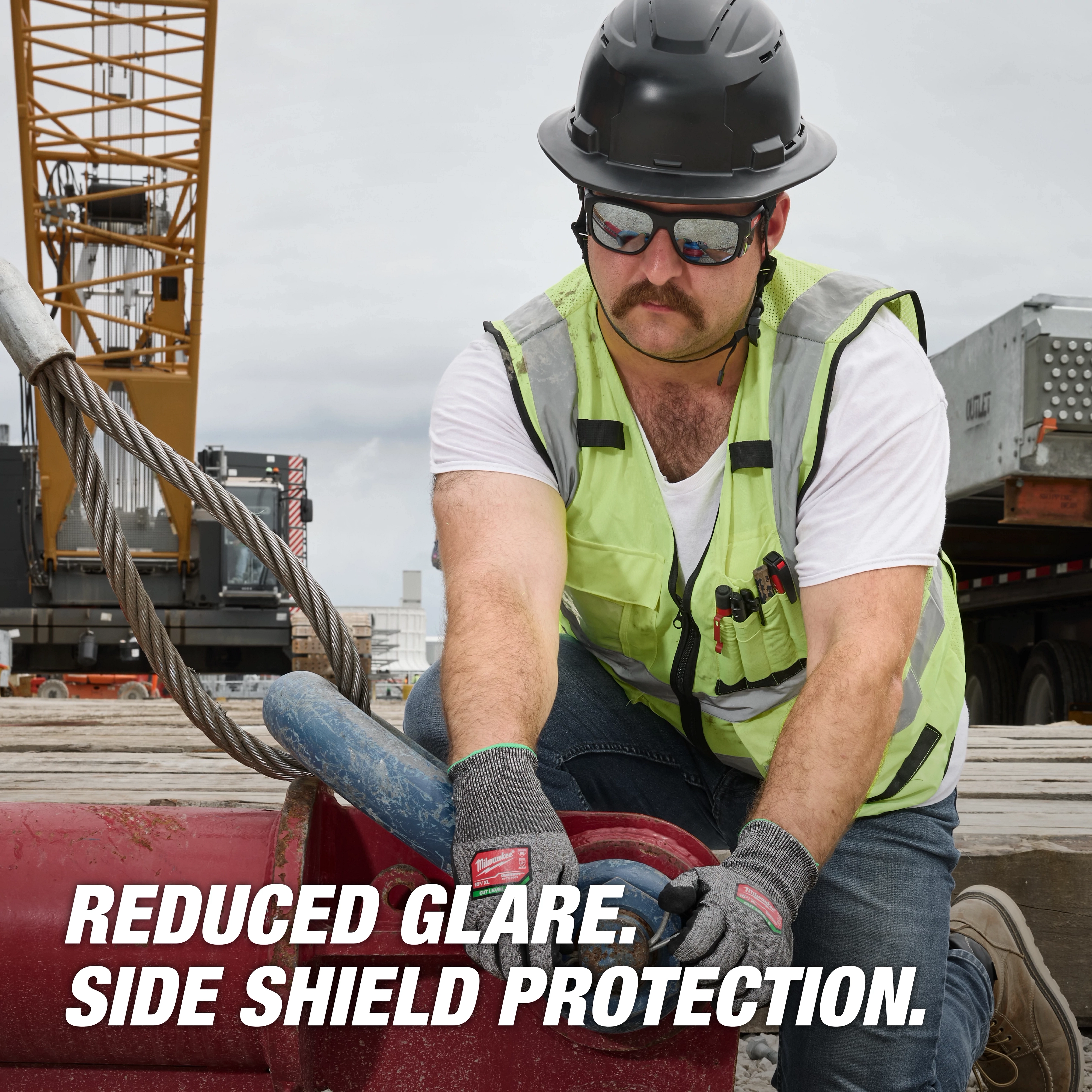 A construction worker wearing a hard hat and reflective vest. Text highlights features of Polarized Full Frame Safety Glasses with Removable Side Shields – Mirrored Dual Coat Lenses.