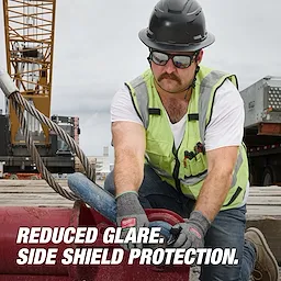 A construction worker wearing a hard hat and reflective vest. Text highlights features of Polarized Full Frame Safety Glasses with Removable Side Shields – Mirrored Dual Coat Lenses.