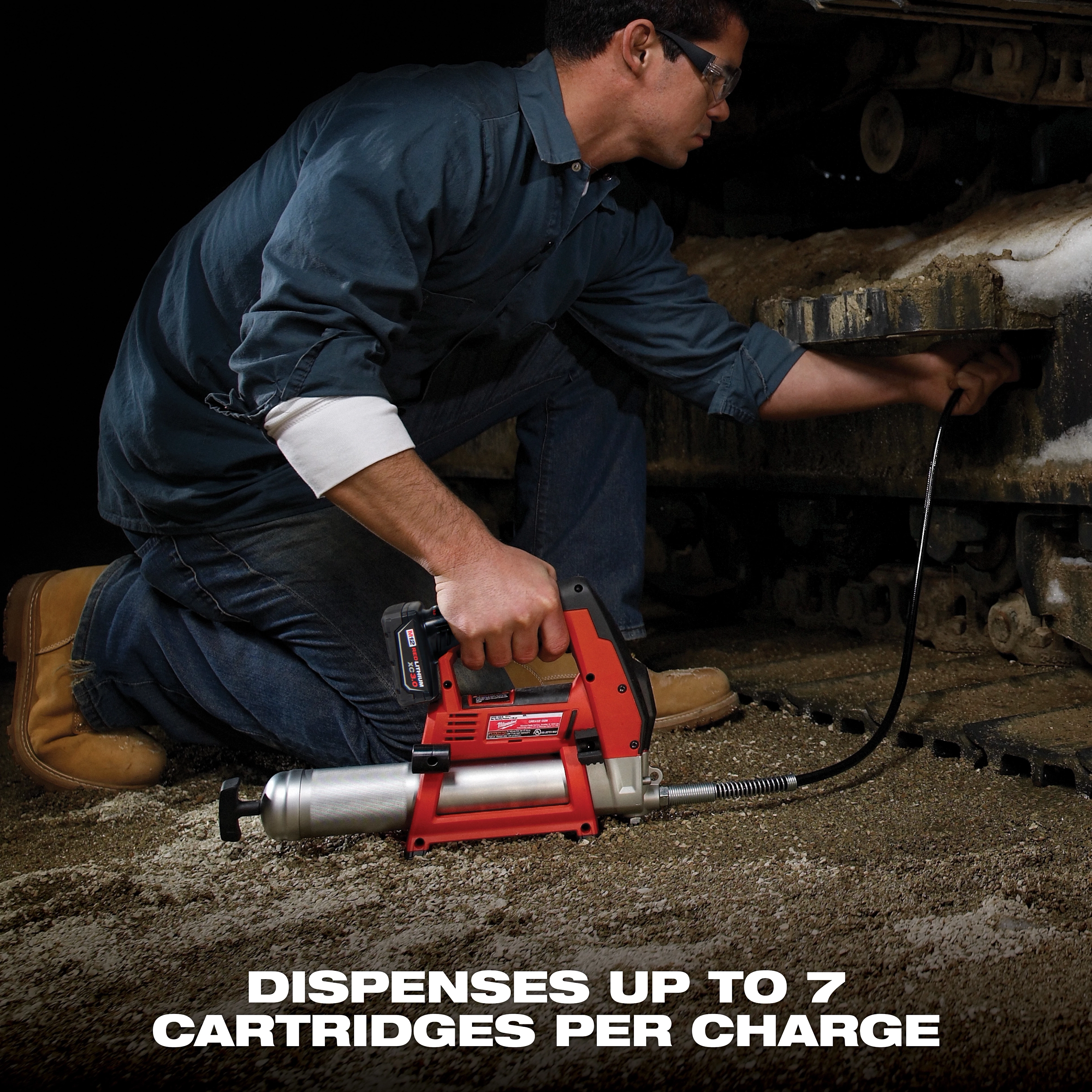 A man uses a red, heavy-duty grease gun to lubricate machinery. Text at the bottom states, "Dispenses up to 7 cartridges per charge."