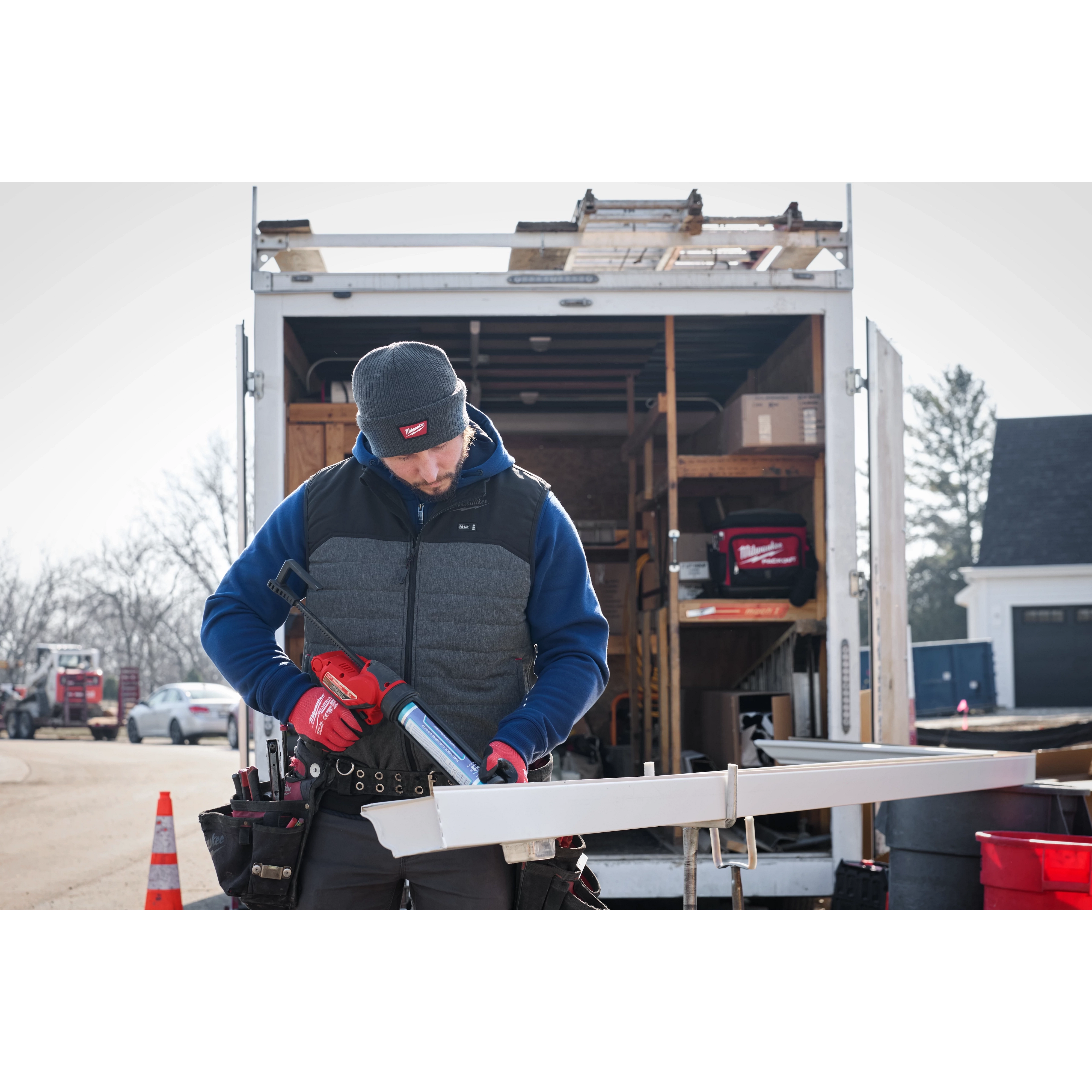 Image of a man on a jobsite wearing the Milwaukee Rib-Knit Cuffed Beanie in gray