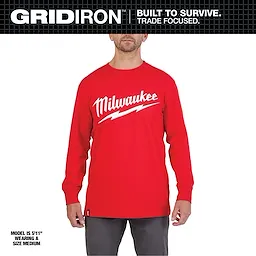 Heavy Duty Tee - Long Sleeve Logo Primary Image displayed in red with white text, worn by a model standing in grey pants.