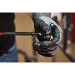 A gloved hand holds the SHOCKWAVE™ Impact Duty 1/4” and 5/16” x 6” QUIK-CLEAR™ 2-in-1 Magnetic Nut Driver.