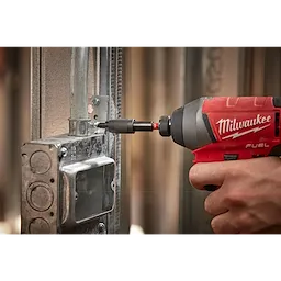 A person uses a Milwaukee drill with a SHOCKWAVE Impact Locking Bit Holder to fasten a screw into a metal electrical box.