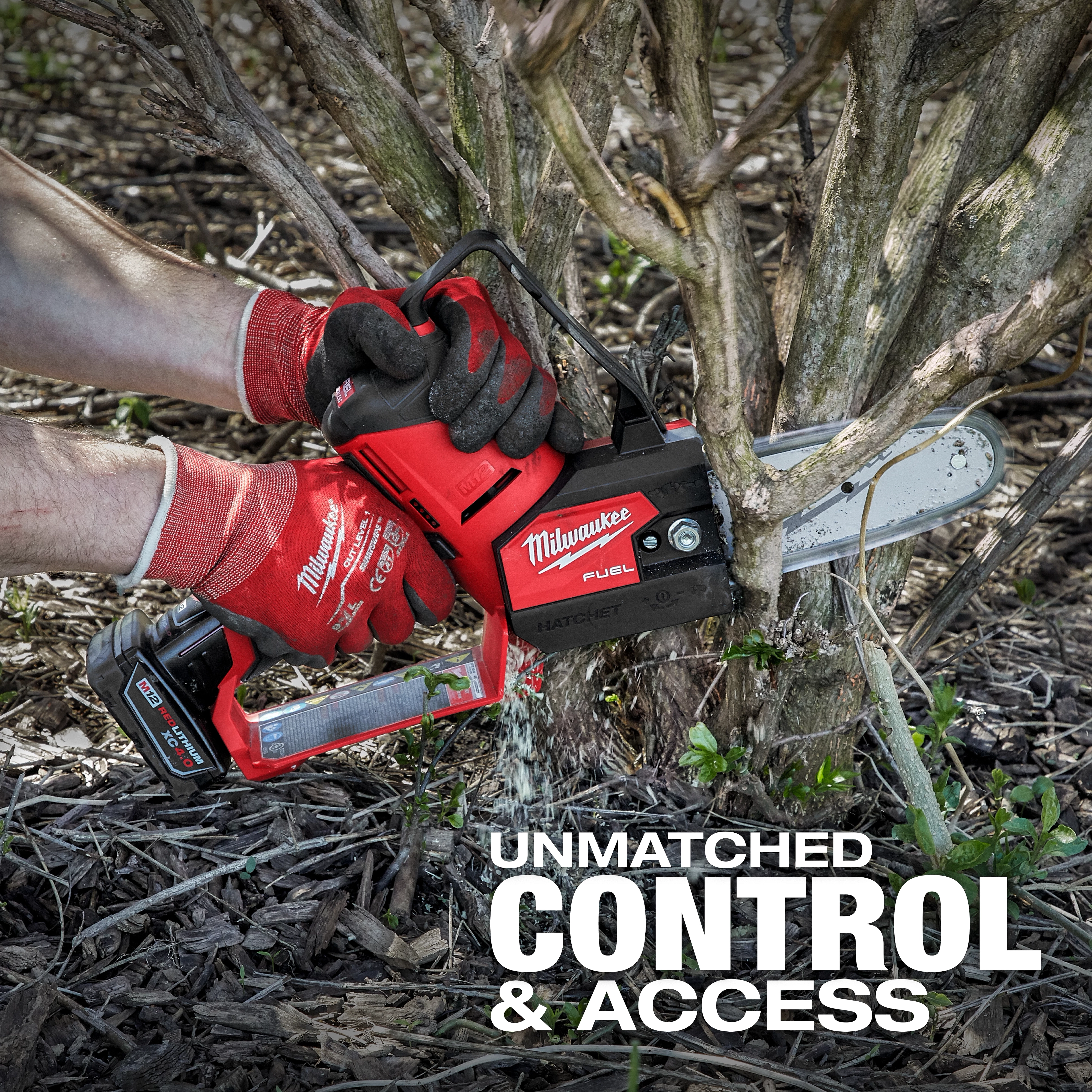 A person using the M12 FUEL™ HATCHET™ 6" Pruning Saw to cut through branches at the base of a shrub. The tool is red with a black handle and has “Milwaukee” branding. The text "UNMATCHED CONTROL & ACCESS" appears at the bottom.