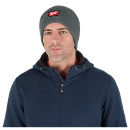 Image of a man wearing the Milwaukee Rib-Knit Cuffed Beanie in green