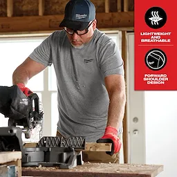 Man using a saw while wearing the Hybrid Work Tee - Short Sleeve Feature Shot. The tee is lightweight and breathable with forward shoulder design.