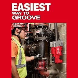 A worker operates the M18 FUEL™ RINGER™ Roll Groover for 1-1/4” - 4” Sch 10/40, 6” Sch 10 on a set of industrial pipes. The image is set against a red background with the text "Easiest Way to Groove."