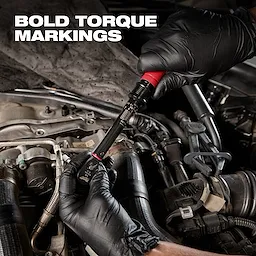 Person wearing black gloves uses the 1/4” Drive Click Torque Wrench (40-200 in·lbf) to adjust a part in a car's engine bay.