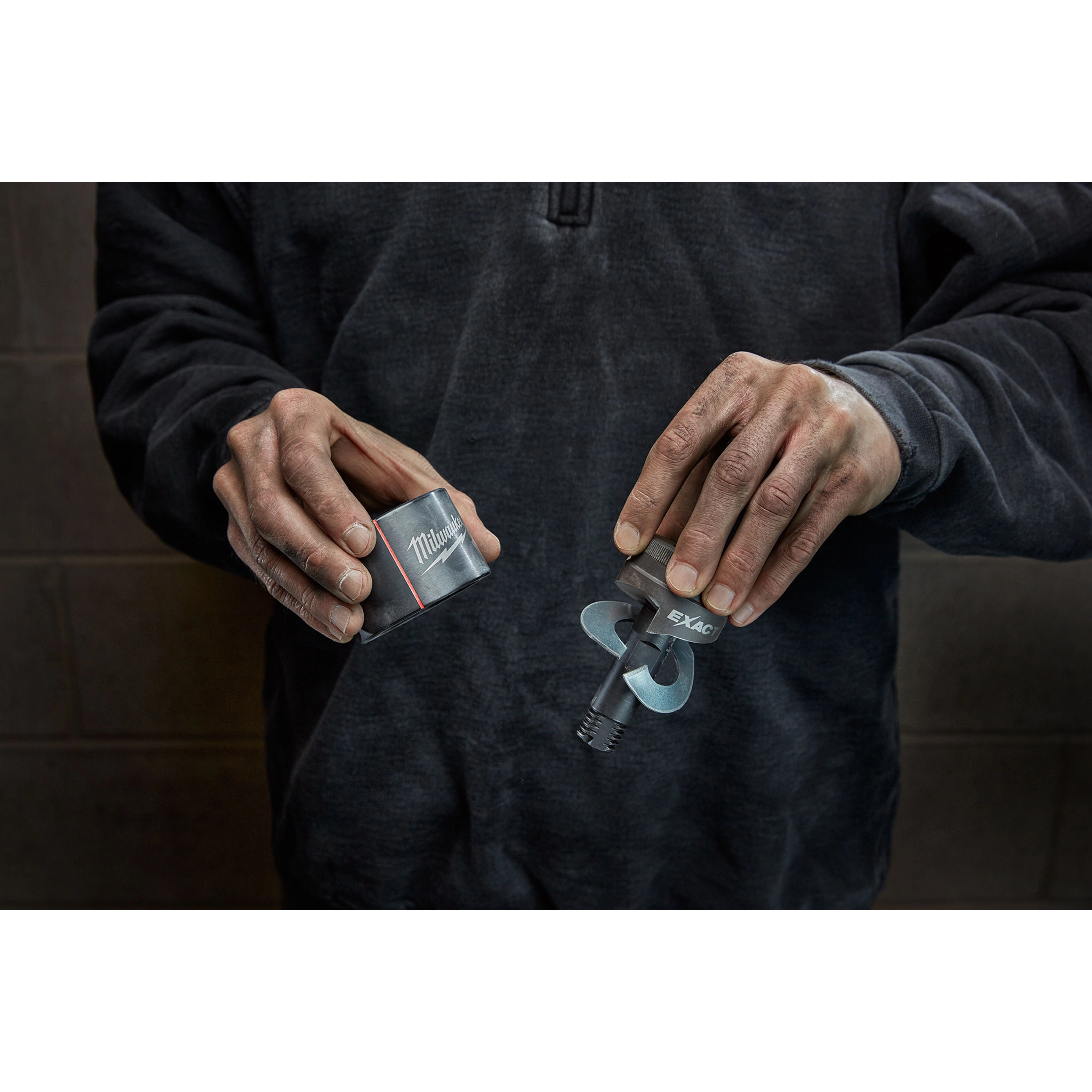 A person holds the Milwaukee Draw Stud tool in their hands, showing the packaged case on the left and the drill bit on the right.