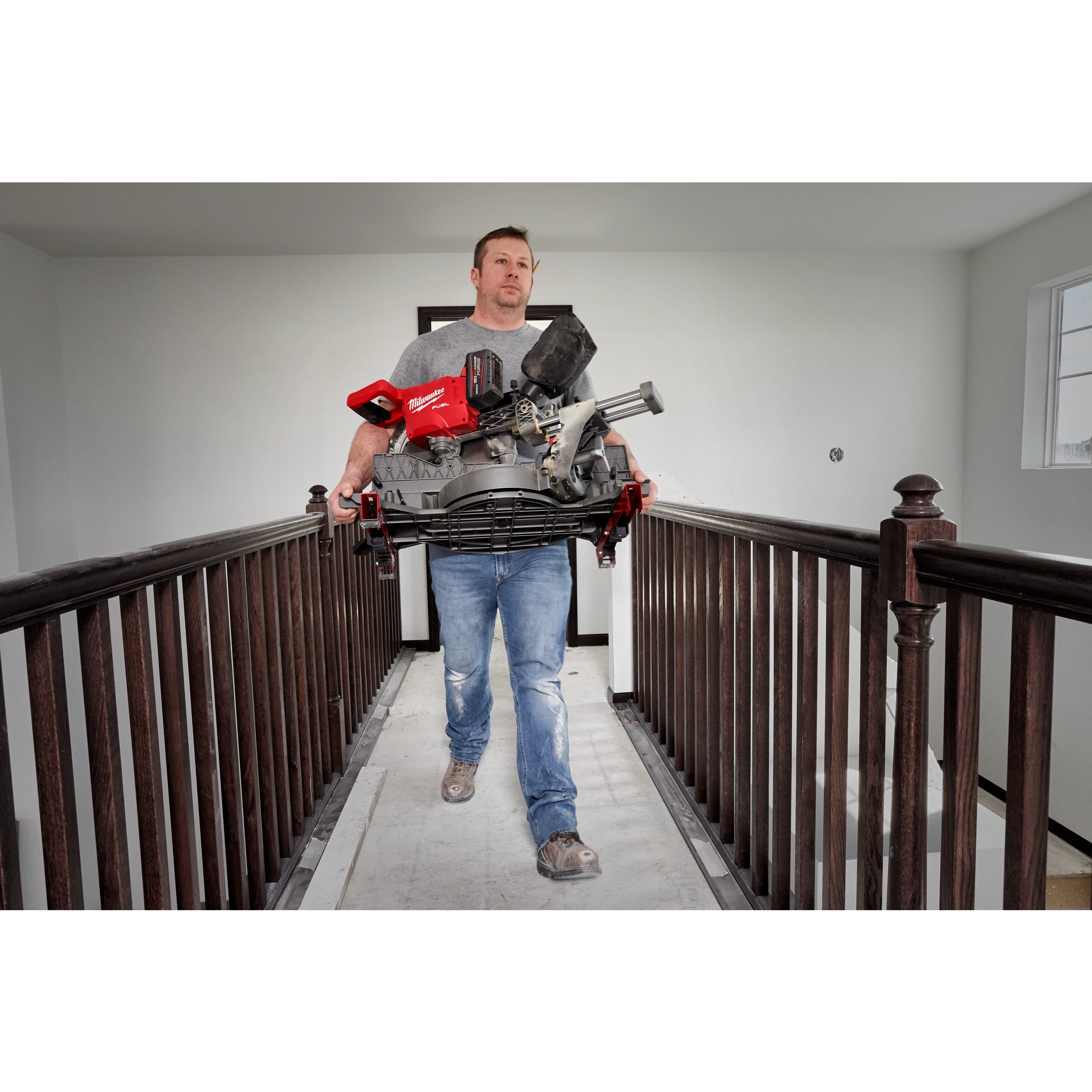 Image of the M18 FUEL™ 12” Dual Bevel Sliding Compound Miter Saw w/ ONE KEY™ being used on a jobsite