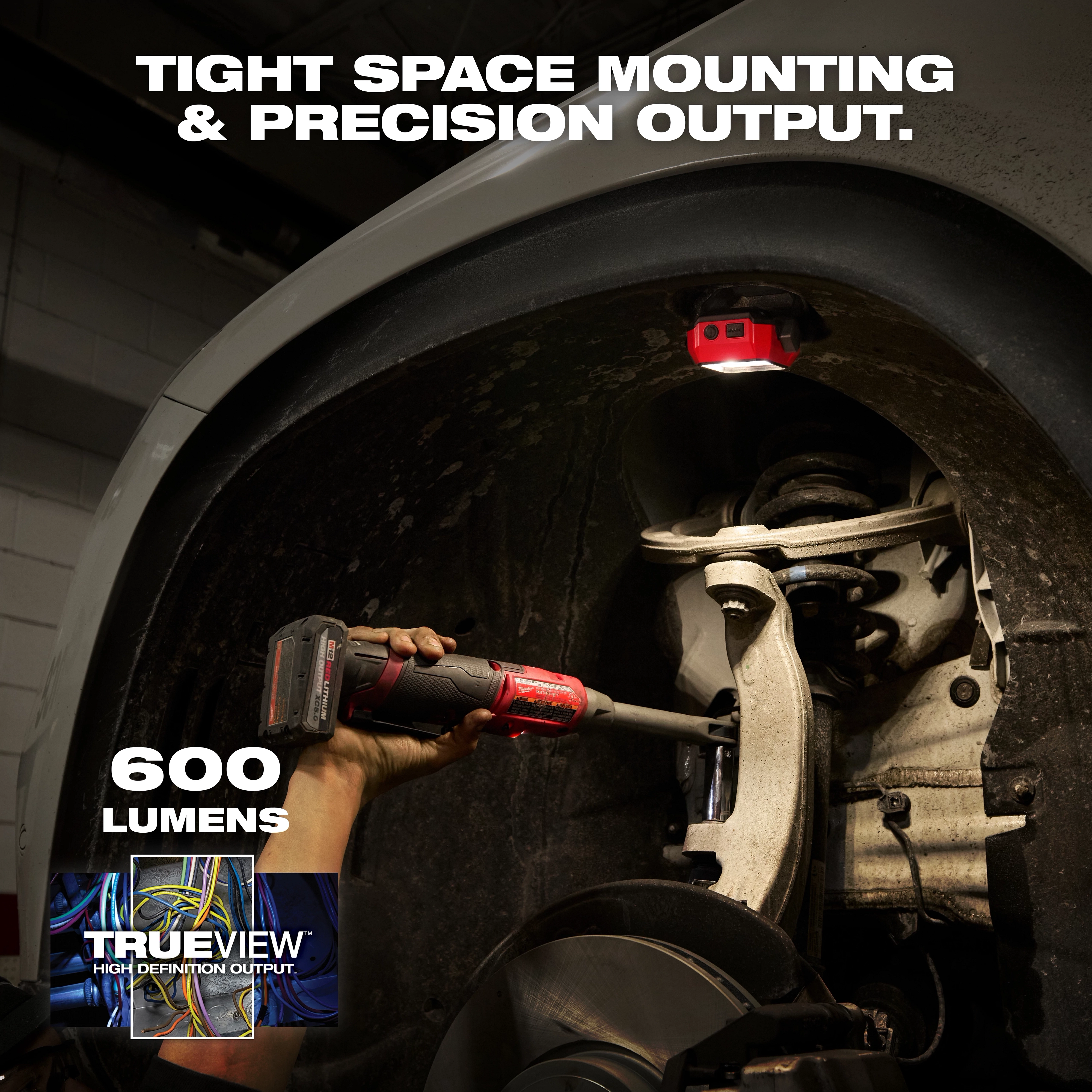 Milwaukee Rechargeable Pivoting Task Light w/ Spot Mode mounted inside a wheel well illuminating suspension parts.