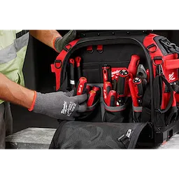 Worker organizing a black and red tool bag filled with a 7pc Metric HollowCore Magnetic Nut Driver Set and a 7pc Metric HollowCore Nut Driver Set.