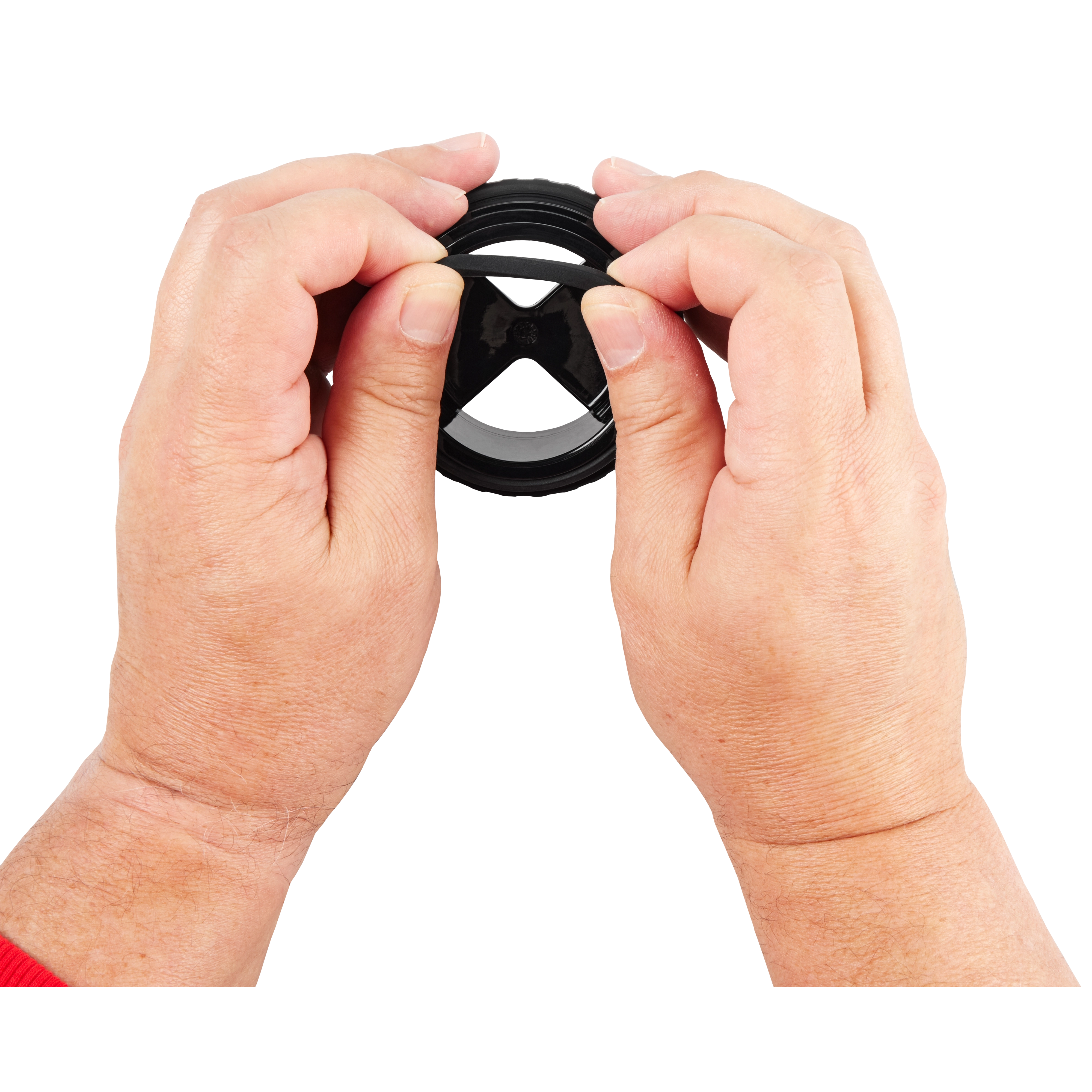 Two hands holding the PACKOUT™ Sip Lid, a black circular plastic lid designed for beverages. The lid has a central opening with a sip hole.