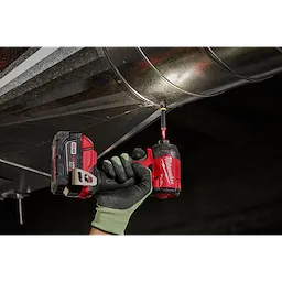 A gloved hand uses a red cordless drill with a SHOCKWAVE 5/16” Insert Magnetic Nut Driver 3PK to secure a metal duct.