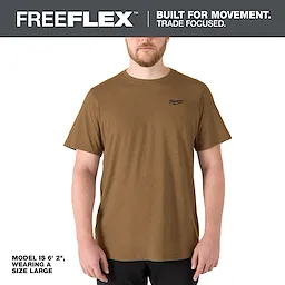 Model wearing the FREEFLEX Hybrid Work Tee - Short Sleeve in brown. Model is 6' 2" and wearing a size large.