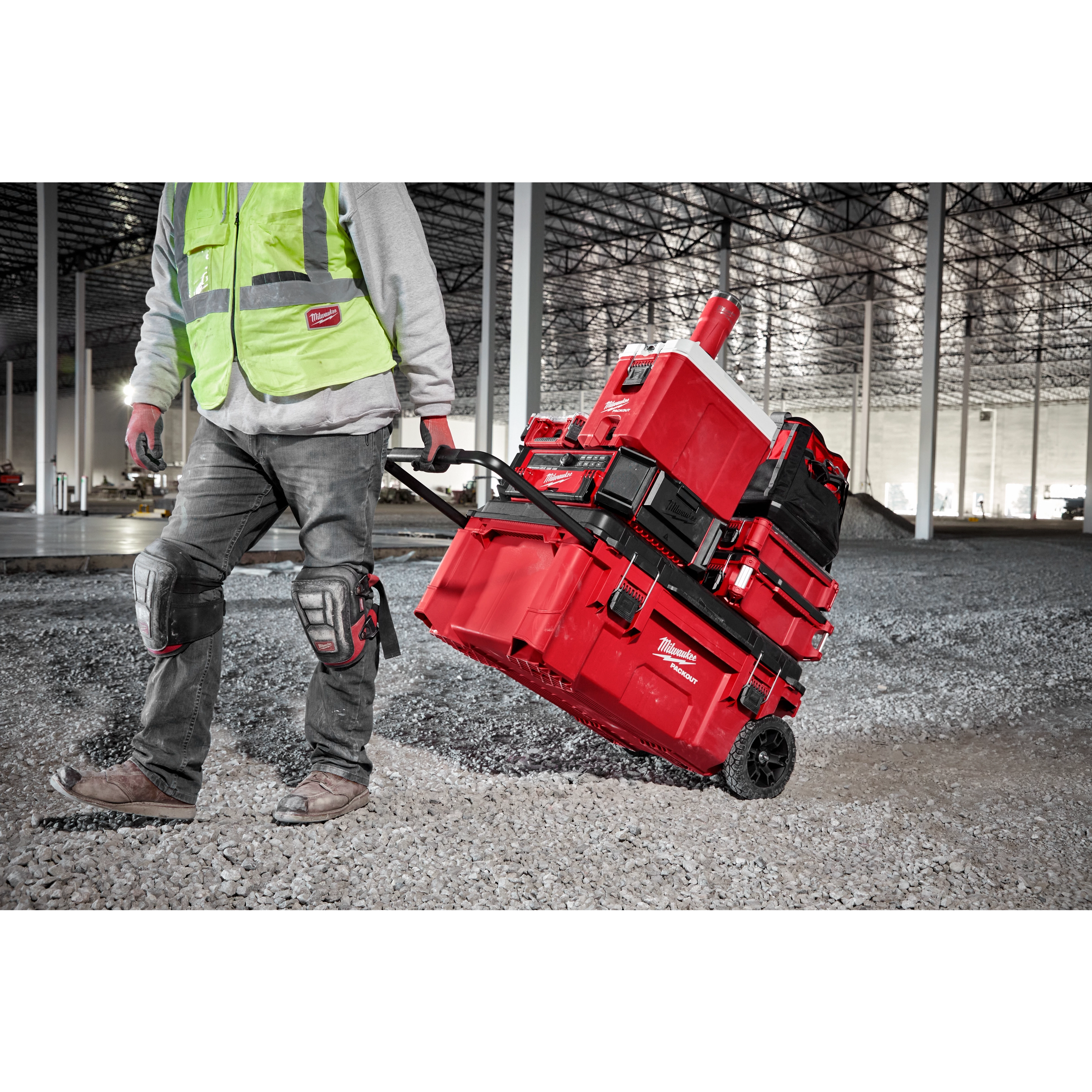 Worker easily pulling the PACKOUT Modular Storage System on the jobsite