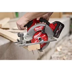 6-1/2” 24T NITRUS Carbide Framing & Demolition Circular Saw Blade cutting a wooden board outdoors.