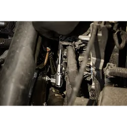 The 1/4" Drive T27 Low-Profile TORX Bit Socket is being used in a mechanical setting, possibly within a vehicle engine compartment.