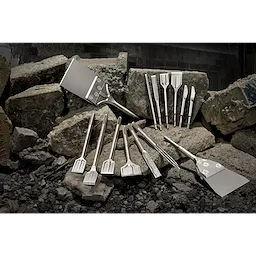August 2023 Sledge Chisel Family Shot showing various sizes and types of chisels arranged on rocks in a construction setting.