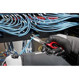Electrician's gloved hands use Electrician Scissors with Extended Handle to cut a blue wire in a networking setup.