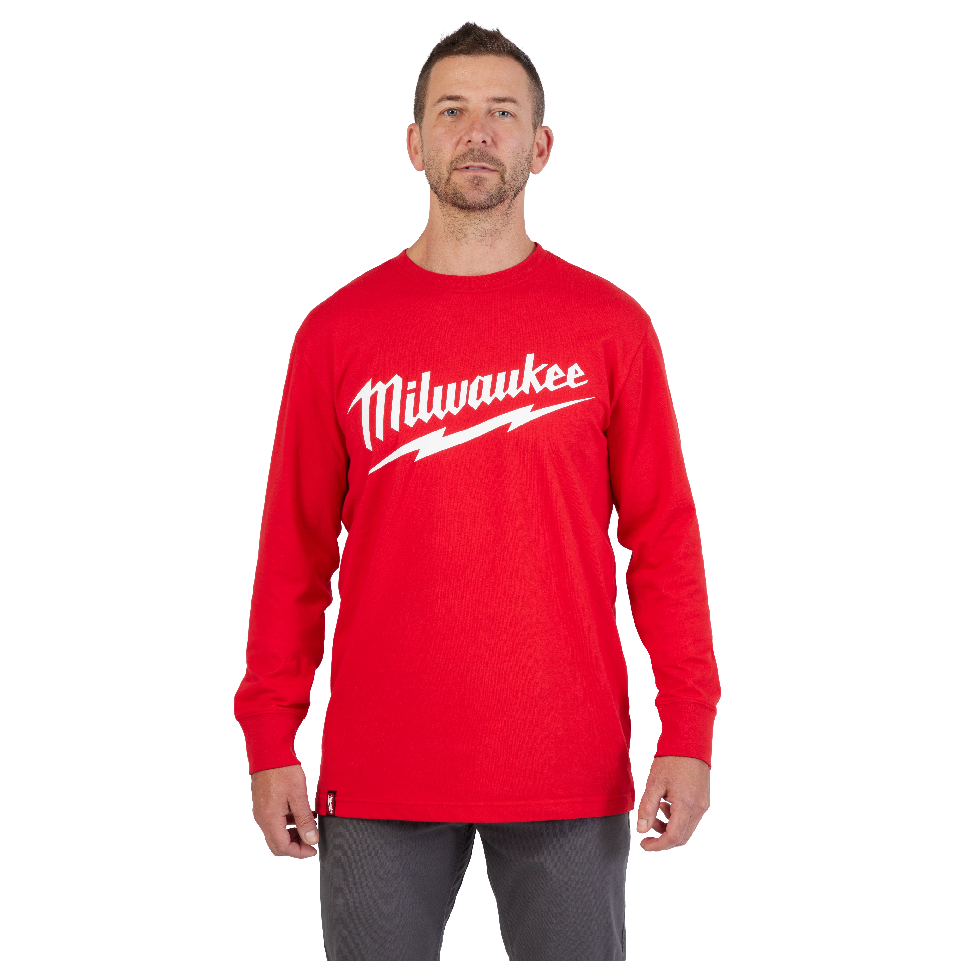 HEAVY DUTY T-SHIRT Long-Sleeve - Red featuring a bold Milwaukee logo and a lightning bolt design, worn by a person.