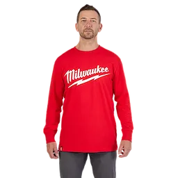 HEAVY DUTY T-SHIRT Long-Sleeve - Red featuring a bold Milwaukee logo and a lightning bolt design, worn by a person.