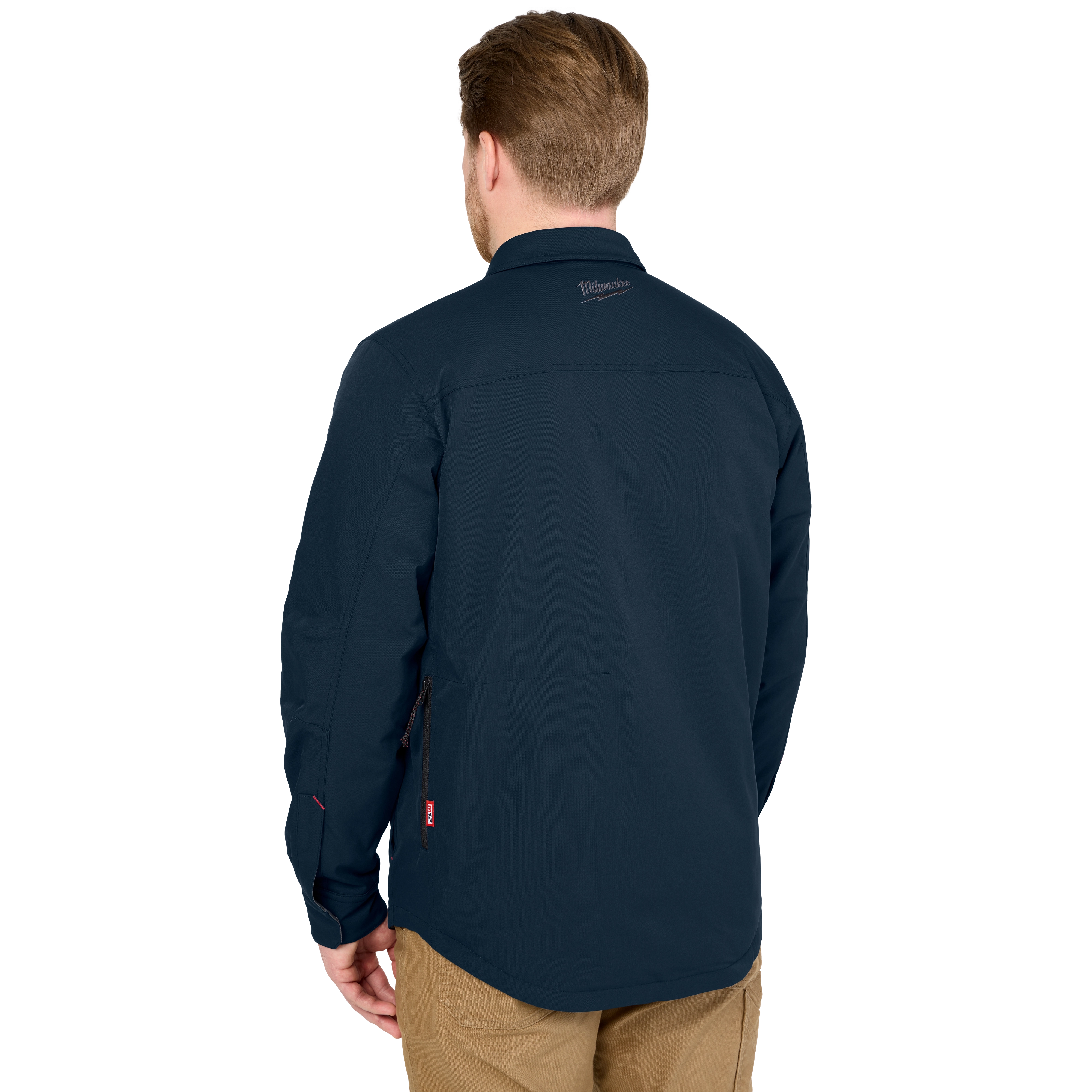 M12 Shirt Jacket in navy blue, shown from the back. The wearer has short hair and the jacket features a logo near the collar.