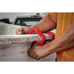 Person attaching a red 3" Bucket Hook to a white container edge with both hands. Another 3" Bucket Hook is seen in the background.