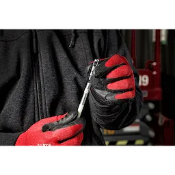 Person wearing red and black gloves holding a part from the 3pc Fish Stick Tip Accessory Kit in a workshop setting.