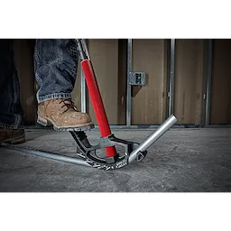 Person using a 3/4" EMT Iron Conduit Bender to bend a metal conduit on a concrete floor. The tool has a red handle.