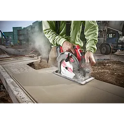Worker cutting fiber cement board with a circular saw equipped with a 7-1/4" PCD/Fiber Cement Circular Saw Blade at a construction site.