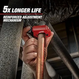 A hand uses the red Milwaukee pipe cutter on a copper pipe, demonstrating its reinforced adjustment mechanism. Text above reads "5x Longer Life."