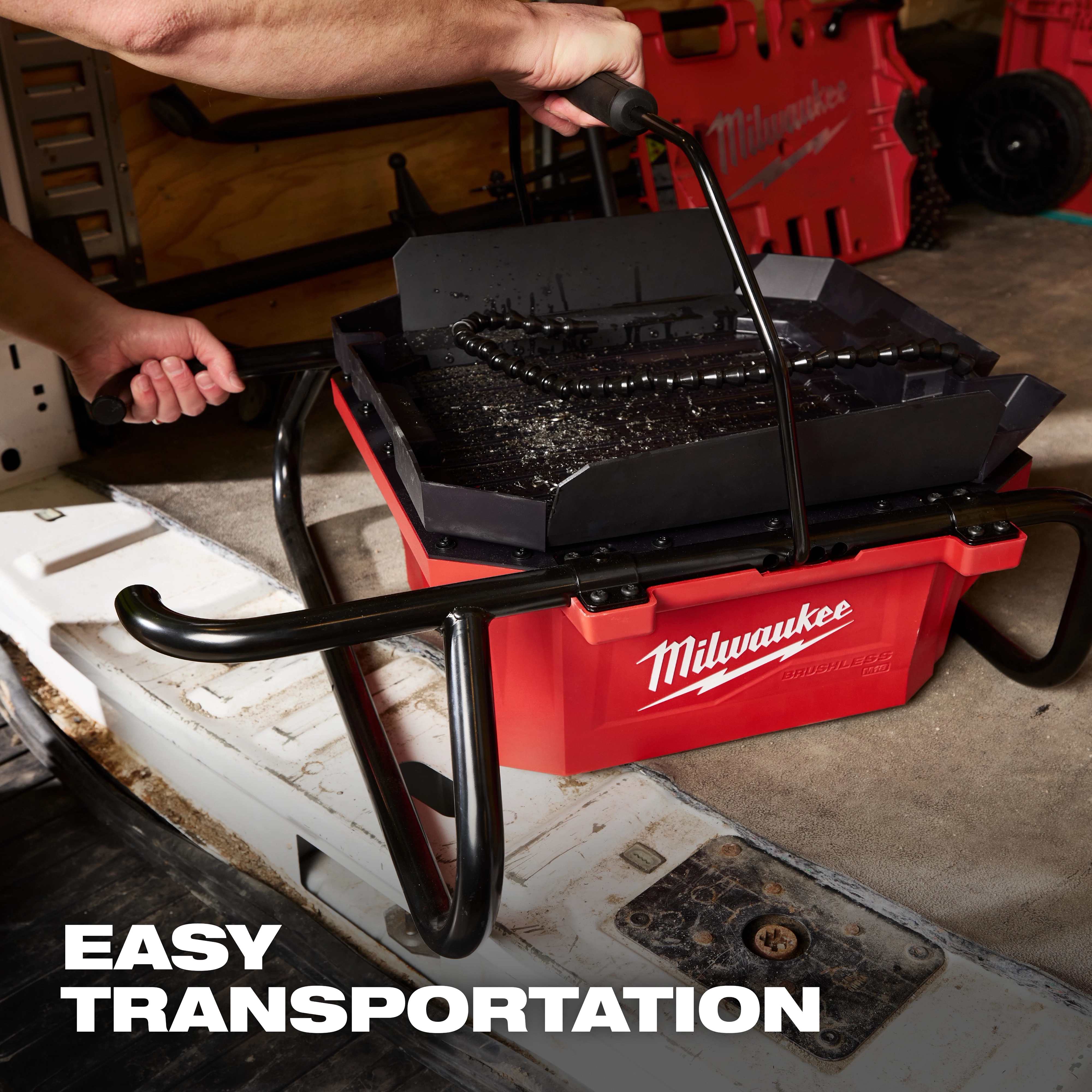 M18 Brushless Pipe Threading Oiler in a red container with a handle being lifted for easy transportation.
