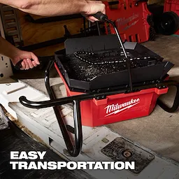 M18 Brushless Pipe Threading Oiler in a red container with a handle being lifted for easy transportation.