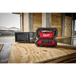 The M18 Carry-On 3600W/1800W Power Supply powering a microwave