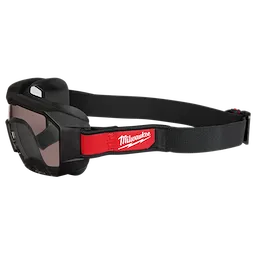Vented Low-Profile Goggles with Tinted Dual Coat Lens featuring a black frame, adjustable strap, and a red section displaying the Milwaukee logo.