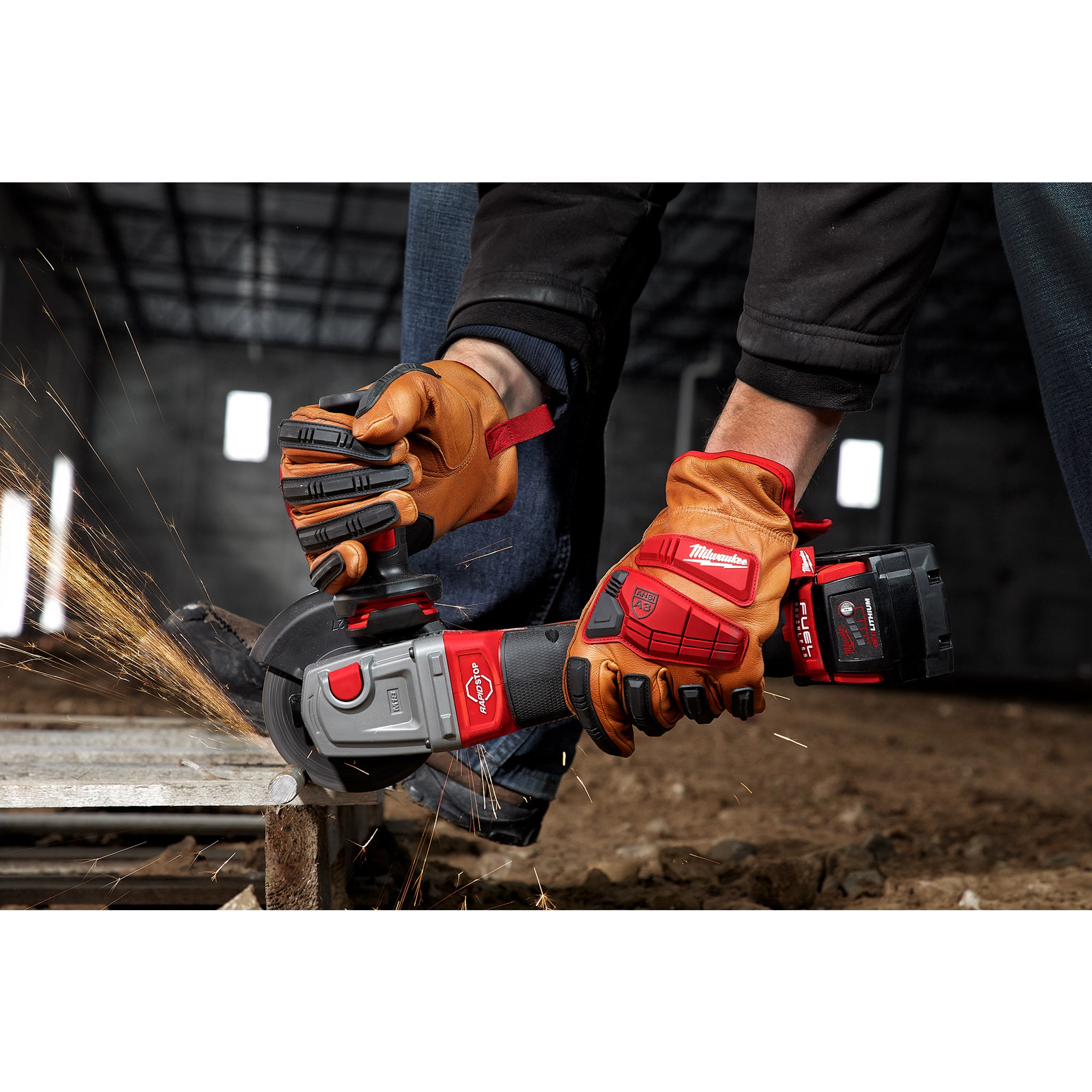Person wearing Impact Cut Level 3 Goatskin Leather Gloves operates a cordless angle grinder, creating sparks while cutting metal.
