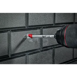 3/8" Glass and Tile Bit drilling into a gray tile wall. The drill bit has a red-tipped point and a silver shaft.