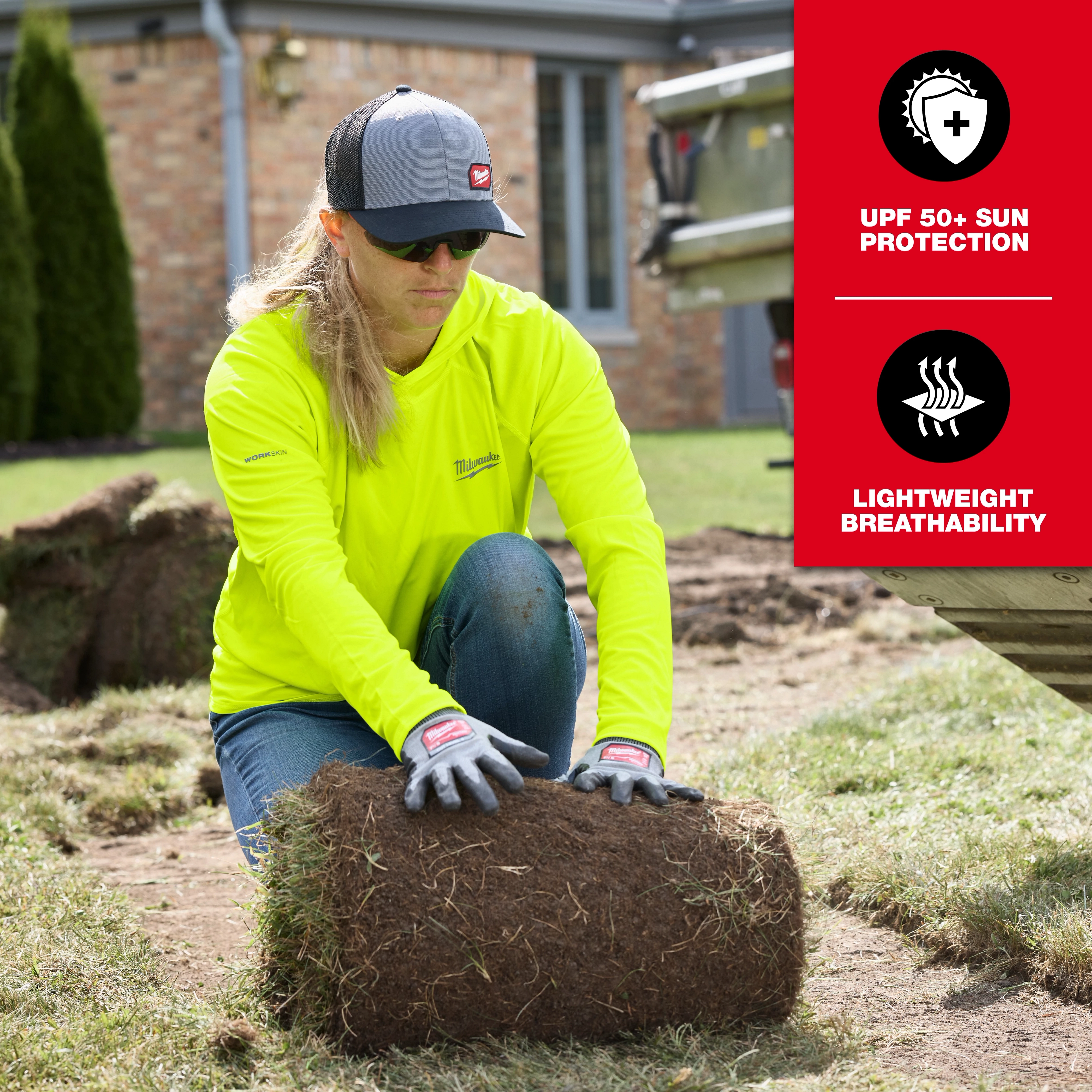 Woman wearing a Women's WORKSKIN Hooded Sun Shirt kneels while handling sod in a yard, highlighting its UPF 50+ sun protection and lightweight breathability.