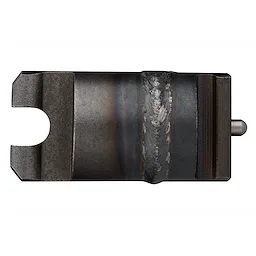 Anchor Adapter for Spartan Machines is a small, rectangular metal component with a central ridge and notches at both ends. It appears to be designed for attachment and reinforcement purposes. The material has a dark, industrial finish with weld marks visible along the center.