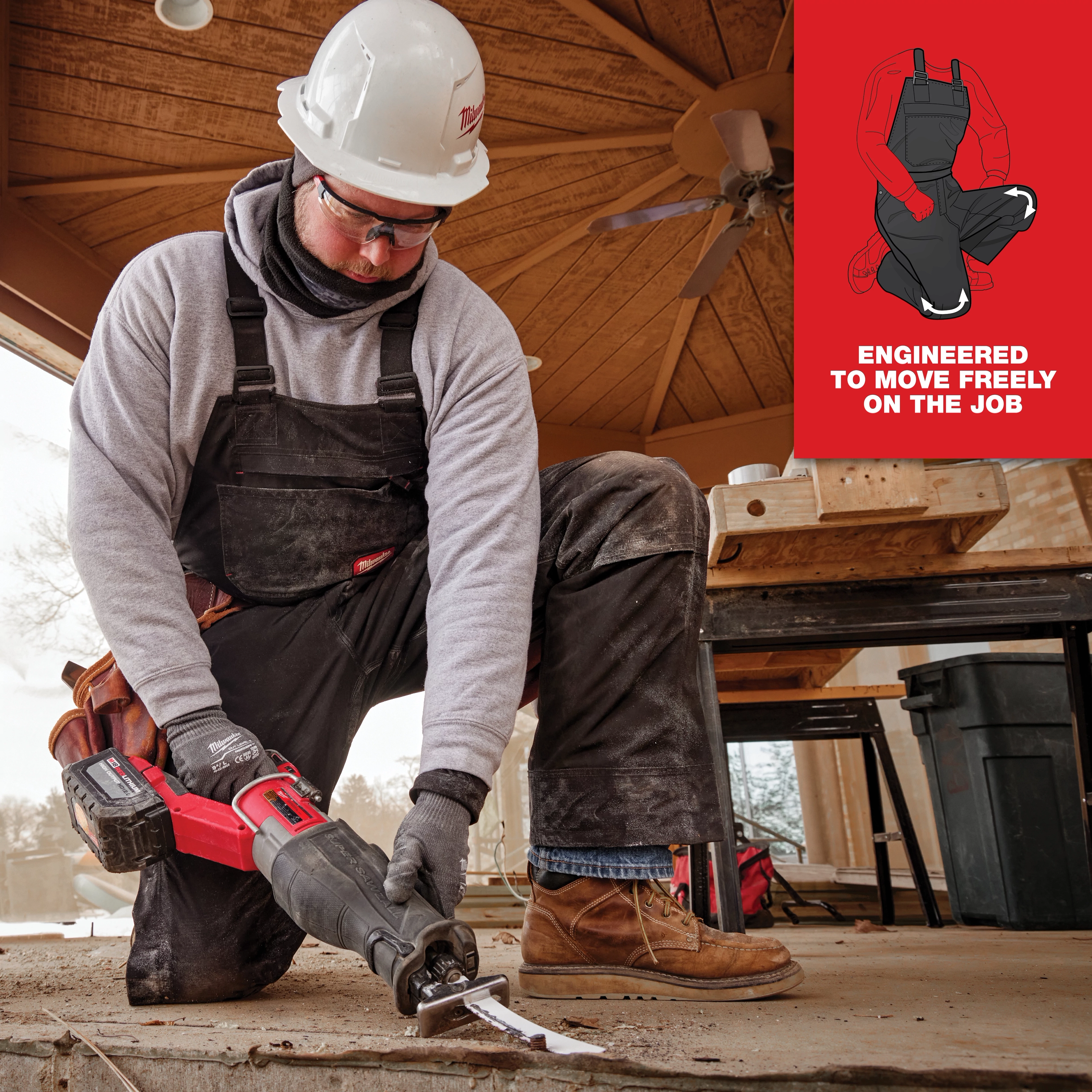 Person kneeling on the job in black FREEFLEX Insulated Bib Overalls with a caption "Engineered to move freely on the job".