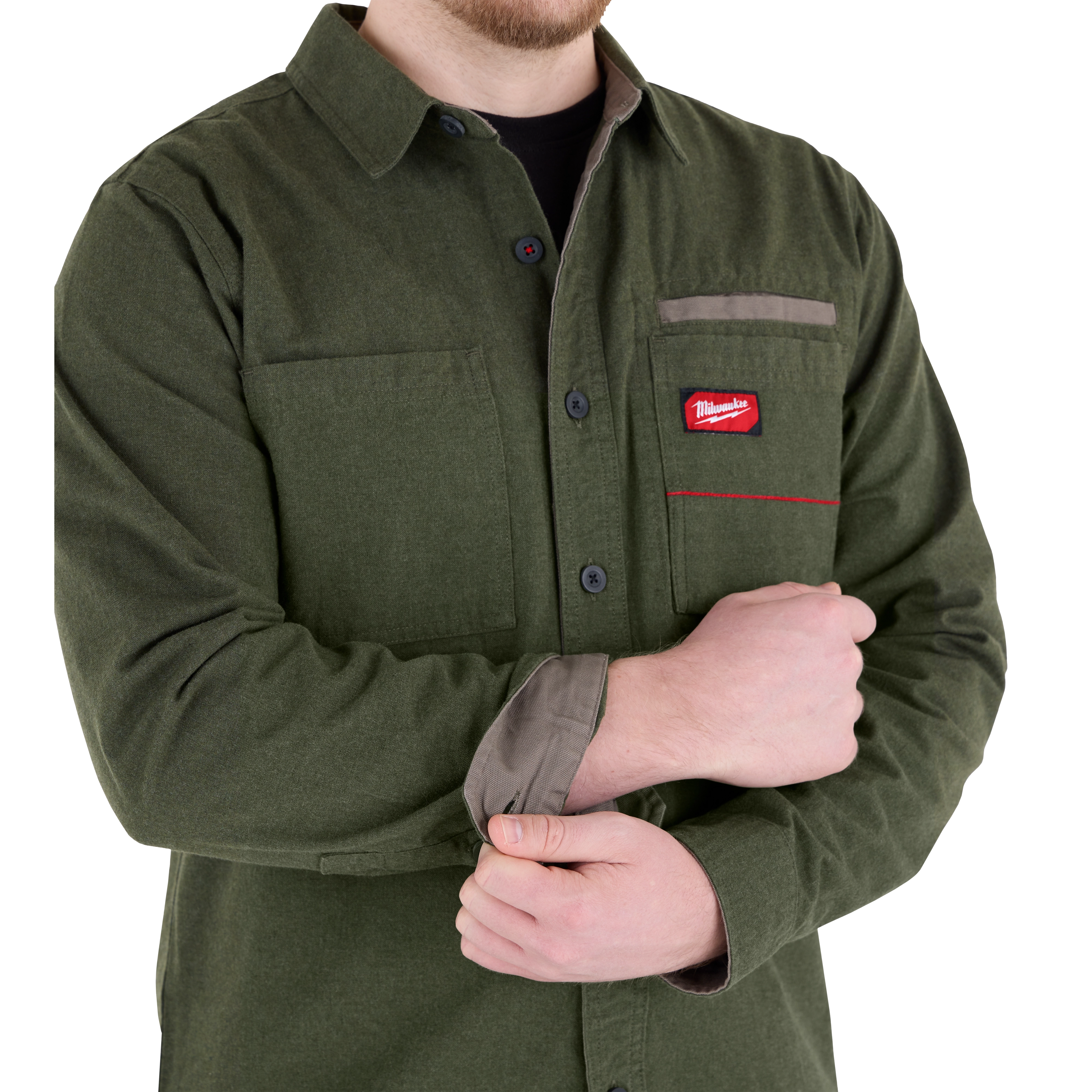 Man wearing a green GRIDIRON Flannel Shirt, adjusting the cuff. The shirt features a chest pocket with a red logo.