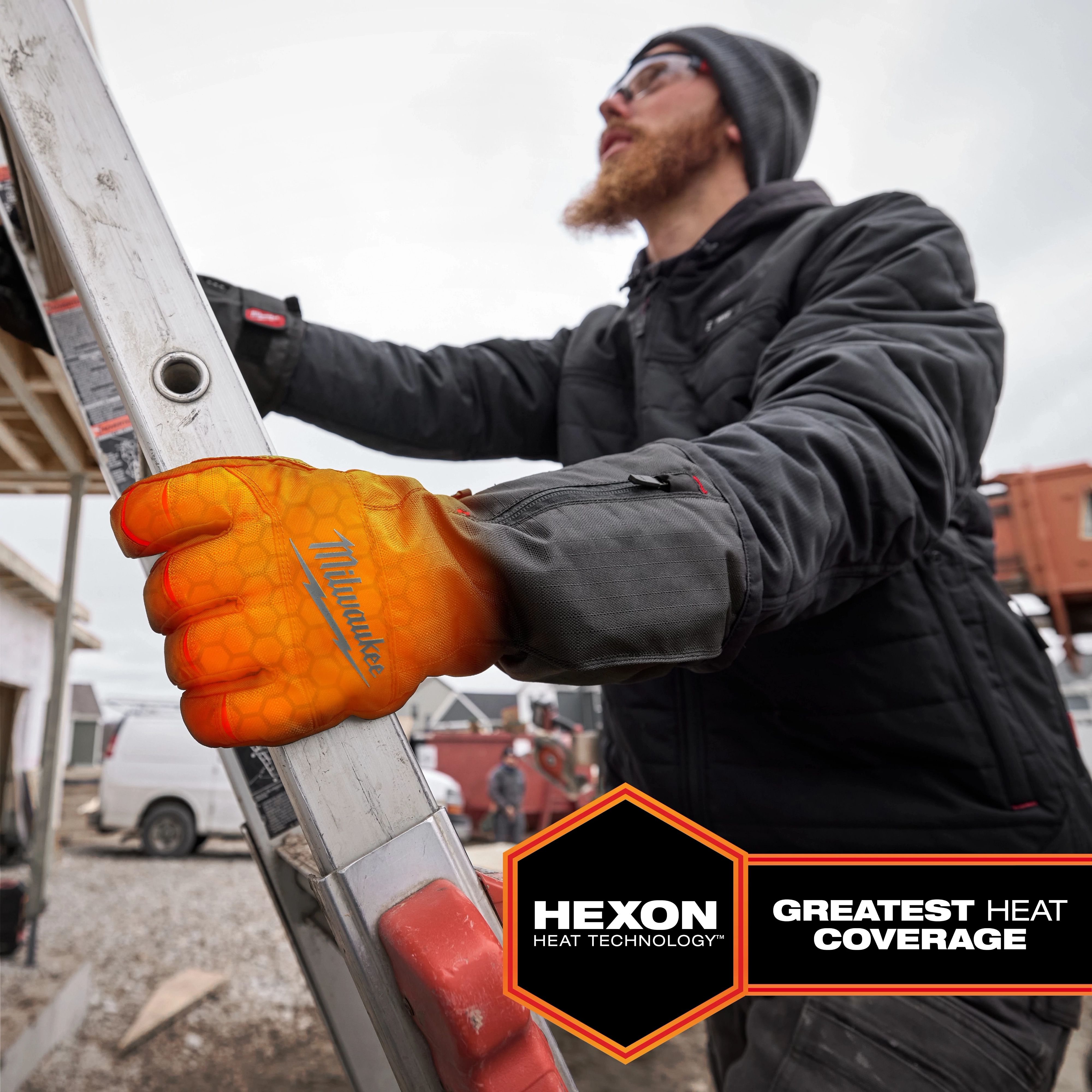 A person wears Heated Winter Gloves while climbing a ladder. The gloves are branded "Milwaukee" and feature Hexon Heat technology, providing the greatest heat coverage.