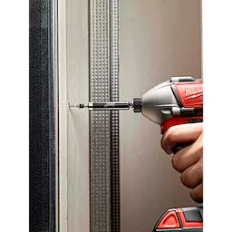 A power drill being used with a Magnetic Bit Holder to screw into a wall. The bit holder securely holds the screw in place.