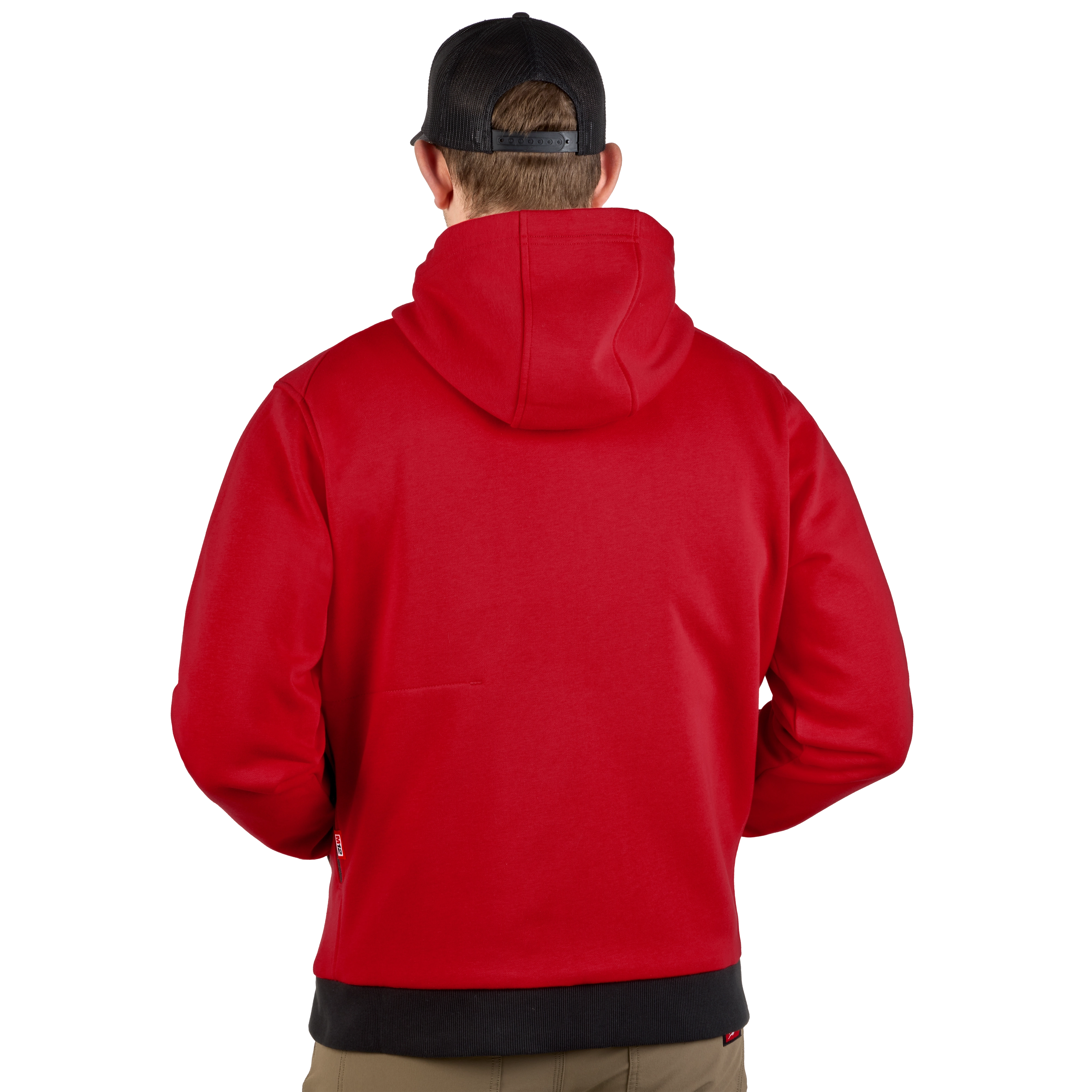A person is shown from the back wearing a red M12™ Heated Hoodie. The hoodie covers the head and has a black waistband. The person is also wearing a black baseball cap, and their hands are in the hoodie's pockets.